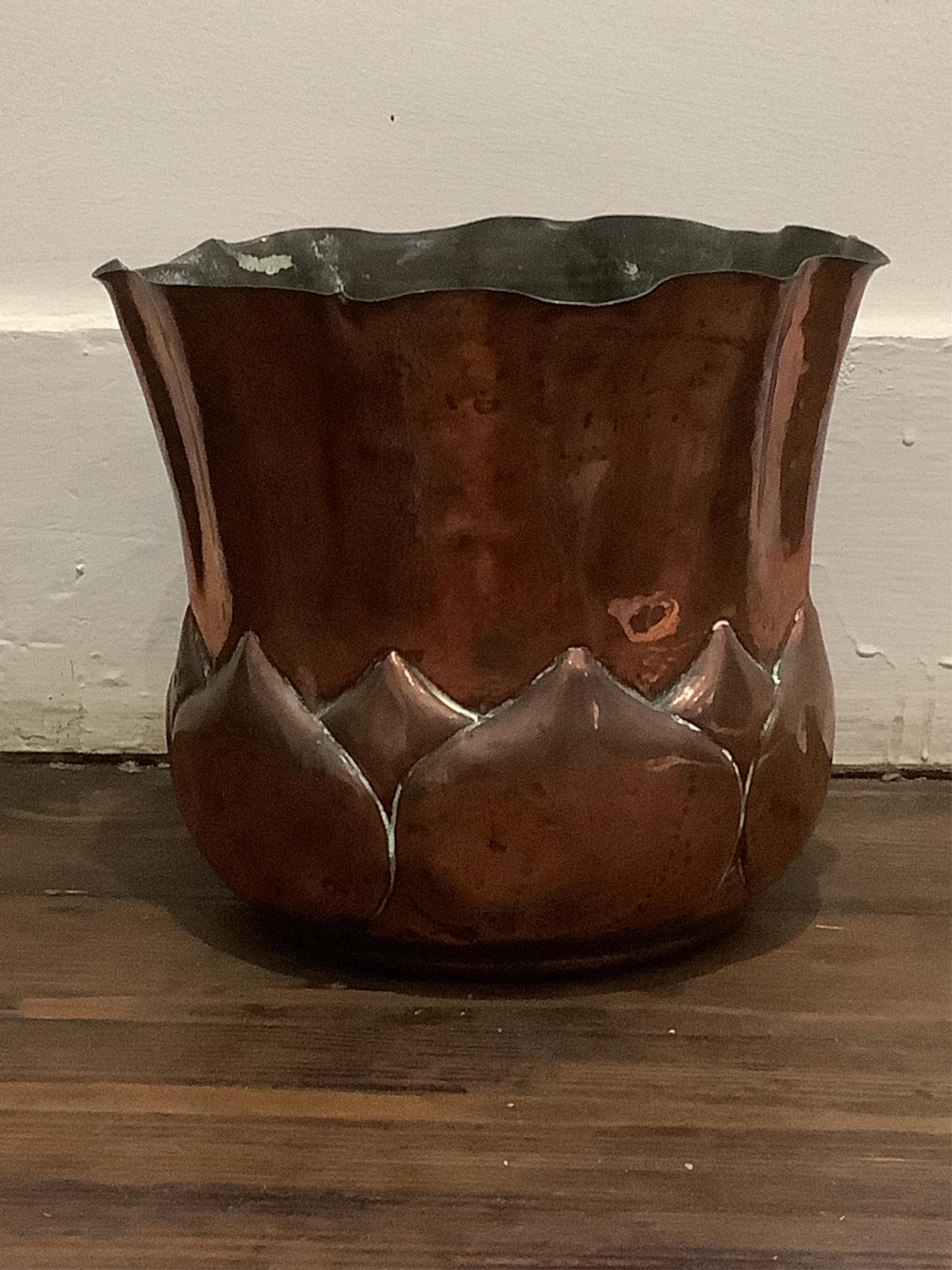A Wlliam Soutter & Sons Arts and Crafts embossed copper jardiniere, impressed mark to the base, 19cm high. Condition - some oxidised splash marks and minor dents